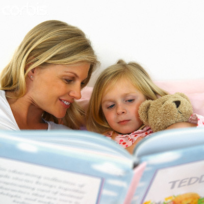 Mother Reading Bedtime Story to Daughter